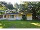 Charming single-story home with a well-maintained lawn and mature trees at 1203 Hawthorne Rd, Hanahan, SC 29410