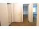 Hallway with three doors and carpeted floors at 1203 Hawthorne Rd, Hanahan, SC 29410