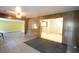 Open-concept living space with view to the kitchen, paneled walls and tile flooring at 1203 Hawthorne Rd, Hanahan, SC 29410