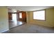 Cozy living room with wood-paneled walls, a large window, and partial carpeting at 1203 Hawthorne Rd, Hanahan, SC 29410
