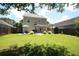 Lush backyard with a patio, hammock, and storage shed, perfect for outdoor activities at 122 Avalon Rd, Summerville, SC 29483