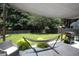 Relaxing backyard with a hammock under a shade sail, perfect for outdoor leisure at 122 Avalon Rd, Summerville, SC 29483