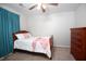 Cozy bedroom features a comfortable bed, dresser, and soft natural light from teal curtains at 122 Avalon Rd, Summerville, SC 29483