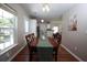 Bright dining room with hardwood floors adjoins kitchen and living areas, fostering social interaction at 122 Avalon Rd, Summerville, SC 29483
