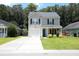 Inviting two-story home featuring a well-manicured lawn and a cozy covered porch at 122 Avalon Rd, Summerville, SC 29483