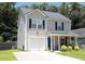 Charming two-story home featuring a welcoming front porch and a one-car garage at 122 Avalon Rd, Summerville, SC 29483