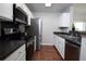 Modern kitchen with stainless steel appliances, dark countertops, and white cabinets at 122 Avalon Rd, Summerville, SC 29483