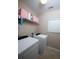 Functional laundry room features modern washer, dryer, and storage shelves for efficient home management at 122 Avalon Rd, Summerville, SC 29483