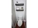 Cozy toilet room with a wall-mounted decorative shelf and a stylish, modern toilet at 122 Avalon Rd, Summerville, SC 29483
