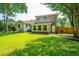Spacious backyard with lush green lawn and a charming home exterior at 1369 Miles Dr, Charleston, SC 29407