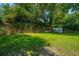 Lush backyard featuring mature trees and a storage shed at 1369 Miles Dr, Charleston, SC 29407