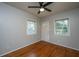 Bright bedroom with hardwood floors, ceiling fan, and natural light from two windows at 1369 Miles Dr, Charleston, SC 29407