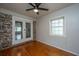 Bedroom with hardwood floors, ceiling fan, and glass patio doors to outside area at 1369 Miles Dr, Charleston, SC 29407