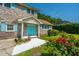 Beautiful brick home with colorful turquoise door/shutters, complemented by vibrant red roses in the front garden at 1369 Miles Dr, Charleston, SC 29407