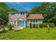 Inviting two-story brick home with well-maintained lawn, garden, and a cozy bench on the front porch at 1369 Miles Dr, Charleston, SC 29407