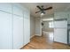Kitchen with white cabinets, stainless appliances and opening through to fireplace at 1369 Miles Dr, Charleston, SC 29407