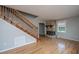 Spacious living room with hardwood floors, stone fireplace, staircase with wooden railing, and neutral paint at 1369 Miles Dr, Charleston, SC 29407
