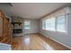 Bright living room featuring hardwood floors, a stone fireplace, and large windows for plenty of light at 1369 Miles Dr, Charleston, SC 29407