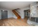 Inviting living room boasting hardwood floors, a cozy stone fireplace, and staircase with natural wood at 1369 Miles Dr, Charleston, SC 29407