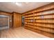 Living room with wood paneling, built-in bookshelves, and hardwood floors at 1369 Miles Dr, Charleston, SC 29407