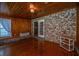 Sunroom with hardwood floors, brick accents, and access door to back of the house at 1369 Miles Dr, Charleston, SC 29407
