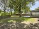 A sprawling backyard with a large tree, a shaded deck, and a sunroom attached to the home at 1410 Diamond Boulevard, Mount Pleasant, SC 29466