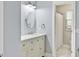A traditional-style bathroom featuring a white vanity with marble countertop and a view of the shower at 1410 Diamond Boulevard, Mount Pleasant, SC 29466