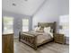 Cozy bedroom with vaulted ceiling, wood-look floors, and rustic wood furniture at 1410 Diamond Boulevard, Mount Pleasant, SC 29466