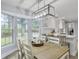 Bright dining room with large windows, modern lighting, and open view to the kitchen at 1410 Diamond Boulevard, Mount Pleasant, SC 29466