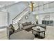 Bright living room featuring staircase, modern decor, vaulted ceilings, and comfortable sofa at 1410 Diamond Boulevard, Mount Pleasant, SC 29466