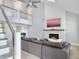 Bright living room featuring modern fireplace, vaulted ceilings, stylish staircase, and comfortable sofa at 1410 Diamond Boulevard, Mount Pleasant, SC 29466