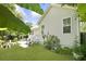 Backyard view featuring a lush green lawn and mature trees, with a cozy outdoor seating area at 1493 Little Rock Blvd, Charleston, SC 29412