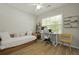 Bright bedroom features natural light, a wooden bed frame, a modern desk and chair, and stylish wood flooring at 1493 Little Rock Blvd, Charleston, SC 29412