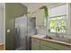 Kitchen view displaying modern stainless steel appliances and light green painted cabinetry at 1493 Little Rock Blvd, Charleston, SC 29412