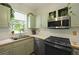 Bright kitchen featuring stainless appliances, neutral backsplash, and natural light from window at 1493 Little Rock Blvd, Charleston, SC 29412