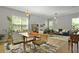 Open-concept living and dining area with a table, chairs, and inviting blue sofa at 1493 Little Rock Blvd, Charleston, SC 29412