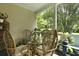 Cozy porch features a glass table and four chairs perfect for enjoying a meal or drinks outside at 1493 Little Rock Blvd, Charleston, SC 29412