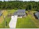 Aerial view of the home displaying the well-manicured lawn, driveway, and proximity to neighboring houses at 1514 Stanwick Dr, Johns Island, SC 29455