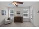 Bedroom featuring a dark wood dresser, white chair, two windows, and a ceiling fan at 1514 Stanwick Dr, Johns Island, SC 29455