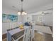 Bright dining room with modern chandelier and view into the living area, perfect for entertaining at 1514 Stanwick Dr, Johns Island, SC 29455