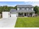 Charming two-story home featuring a well-manicured lawn and an inviting covered front porch at 1514 Stanwick Dr, Johns Island, SC 29455