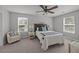 Serene bedroom featuring two large windows, cozy seating and a comfortable bed with stylish bedding at 1514 Stanwick Dr, Johns Island, SC 29455