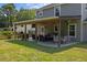 Inviting covered patio with comfortable seating, perfect for relaxing and enjoying the peaceful backyard setting at 1514 Stanwick Dr, Johns Island, SC 29455