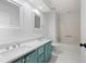 Bright bathroom with double sinks, white cabinets, and tile flooring at 1530 Fort Johnson Rd # 2E, Charleston, SC 29412