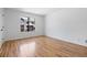 Bright bedroom with hardwood floors and a large window offering neighborhood views at 1530 Fort Johnson Rd # 2E, Charleston, SC 29412