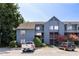 Multi-story home exterior with blue siding and parked vehicles, showcasing curb appeal at 1530 Fort Johnson Rd # 2E, Charleston, SC 29412
