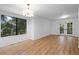 Open living space with wood floors, a large window, and French doors filling the room with light at 1530 Fort Johnson Rd # 2E, Charleston, SC 29412