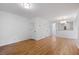 Open-concept living area featuring wood floors, white walls, and access to other rooms in the home at 1530 Fort Johnson Rd # 2E, Charleston, SC 29412