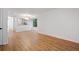 Spacious living room with wood floors, connecting to a kitchen area with natural light and neutral paint at 1530 Fort Johnson Rd # 2E, Charleston, SC 29412