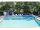Community pool with chairs and a fence surrounding the area at 1530 Fort Johnson Rd # 2E, Charleston, SC 29412